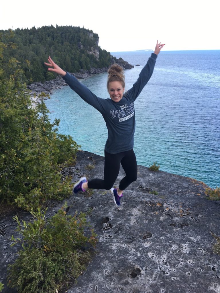 Woman celebrating wellness outdoors in Ottawa