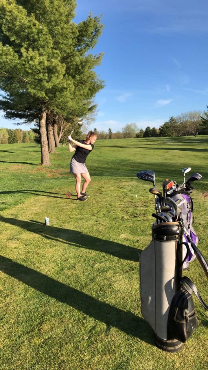 Chiropractor demonstrating golf swing in Ottawa.