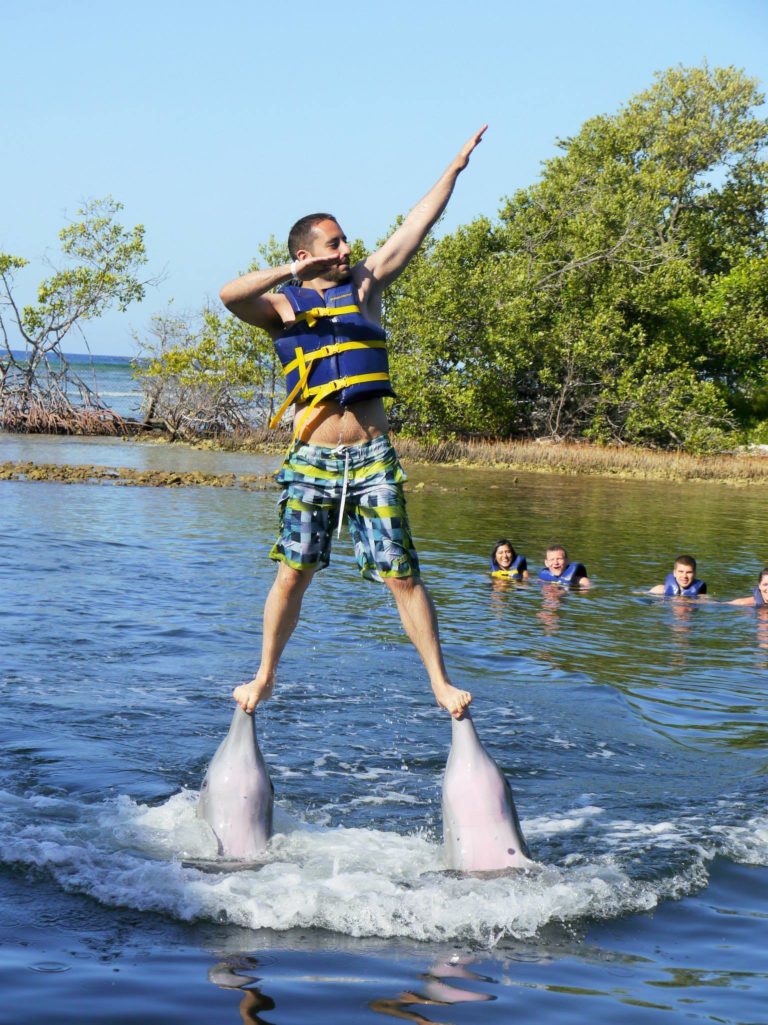 Man performing a double dolphin lift in water.