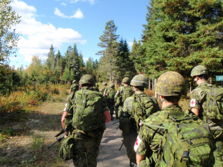 Soldiers on a forest ruck march exercise.