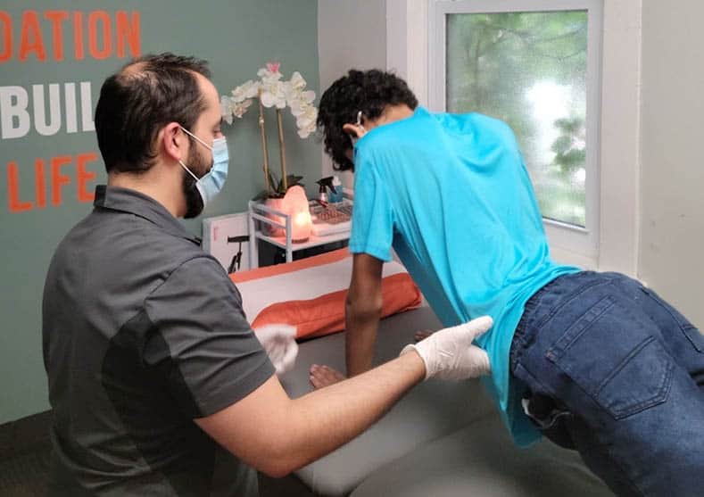 Physiotherapist guiding patient in Ottawa clinic.