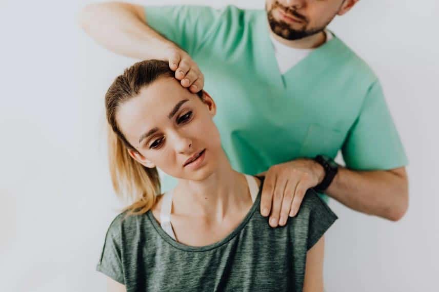 Physiotherapist assisting patient with neck pain relief.