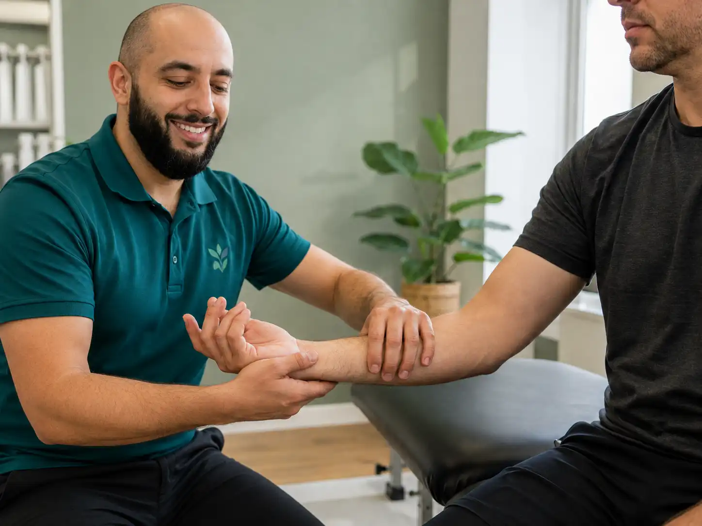 Physiotherapist assessing a patients wrist and forearm at Kent Chiro Med in Ottawa