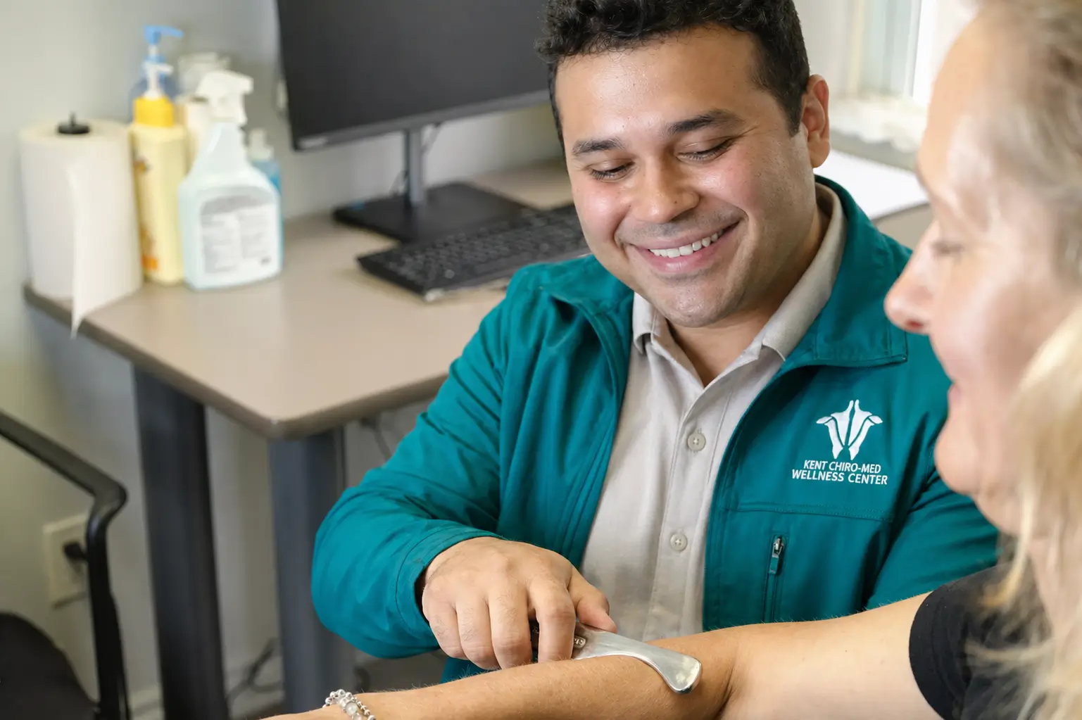 Kent Chiro Med chiropractor performing Graston Technique on a patients forearm in an Ottawa clinic