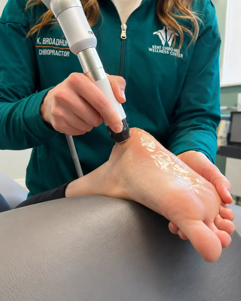Dr Courtney Broadhurst providing plantar fasciitis treatment with therapy equipment at Kent Chiro Med Wellness Clinic in Ottawa