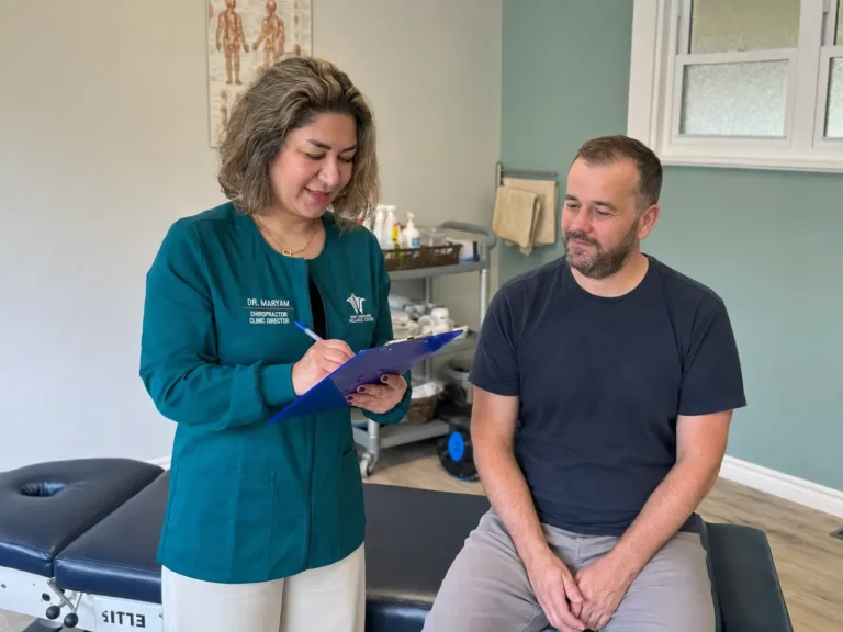 Maryam Practitioner discussing symptoms with a patient during a consultation at Kent Chiro Med Wellness Clinic in Ottawa