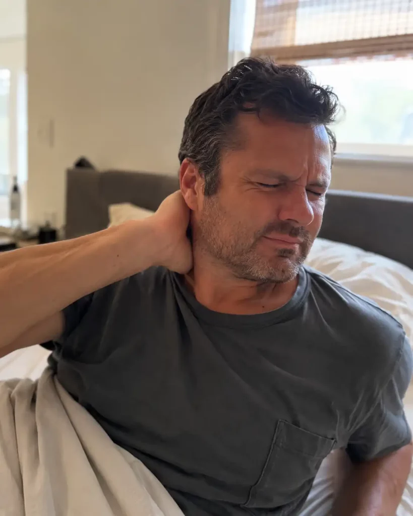 Person sleeping with their head twisted at an awkward angle that can cause neck pain