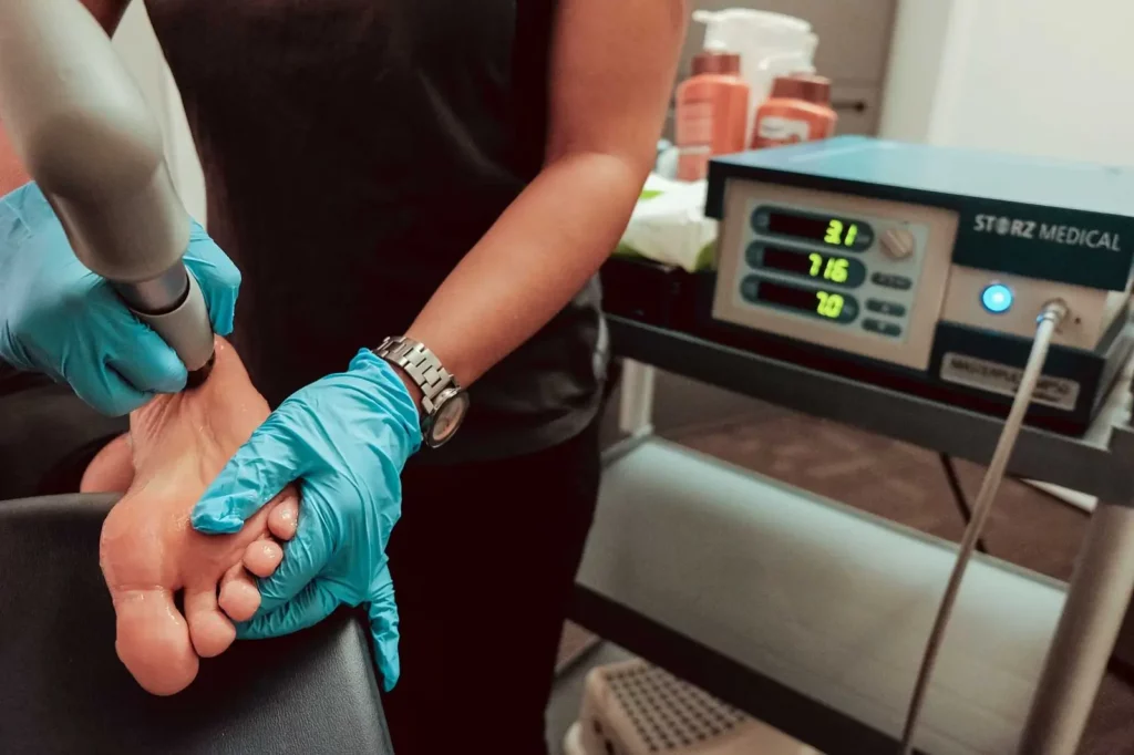 Dr. Maryam assessing a patients foot and ankle during shockwave treatment